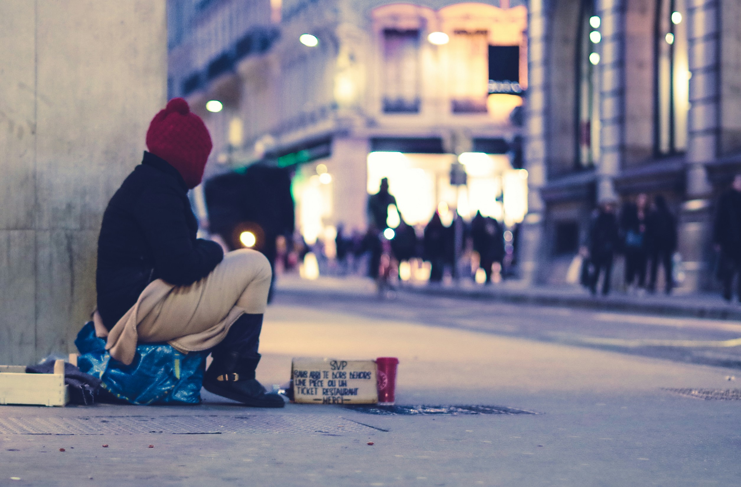 Homeless Person by the side of the pavement. Photo by EV on Unsplash